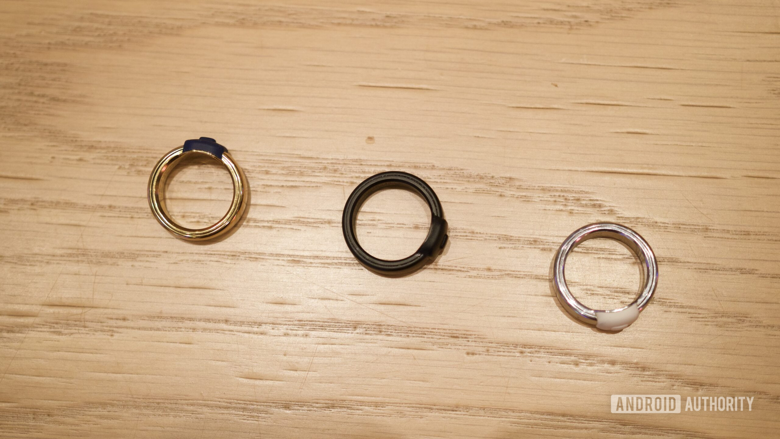 Três anéis Pebble Index 01 colocados sobre uma mesa.