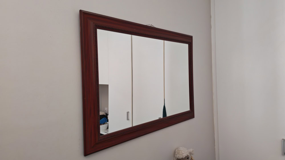 um espelho na parede com sua mancha original